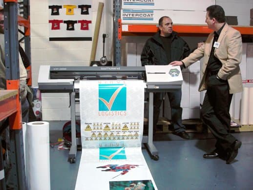 Simon from LSU, talking to customer with Roland Versacamm VP300 in the foreground.