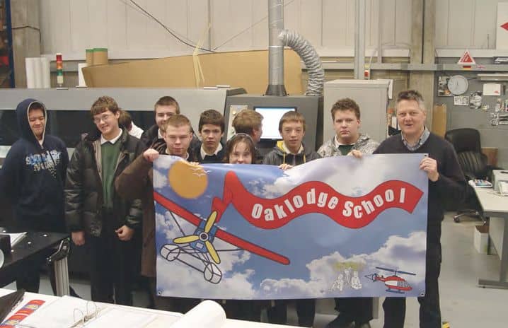 Students of Oak Lodge show off their school flag. Students of Oak Lodge showing off their school flag.