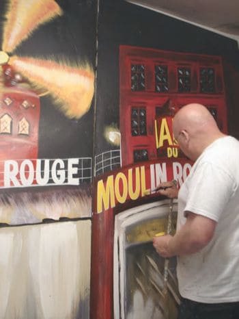 Wayne working with a paintbrush on a prestigious project.