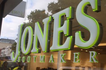 View from outside glass, with LED illumination through Perspex letter face.