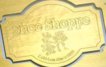 A wooden 3D sign saying 'The village Inn'