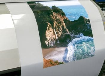 KODAK Backlit Film coming out of a printer.