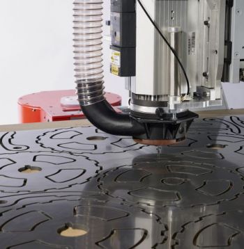 Acrylic being routed by a CNC machine